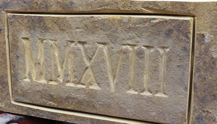 Date carved into stone block